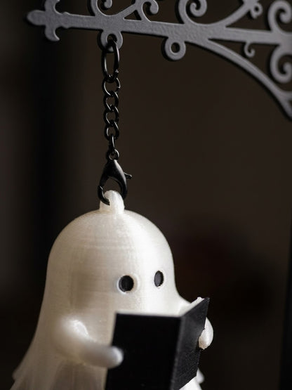 Ghost Bookshelf Lantern iron bookend holding up a row of books in a cozy reading nook