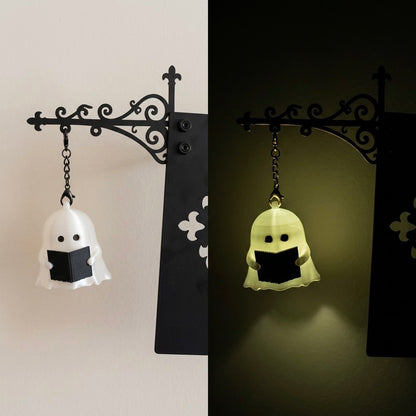 Cordless ghost bookend light with iron scroll bracket and resin ghost reading a book